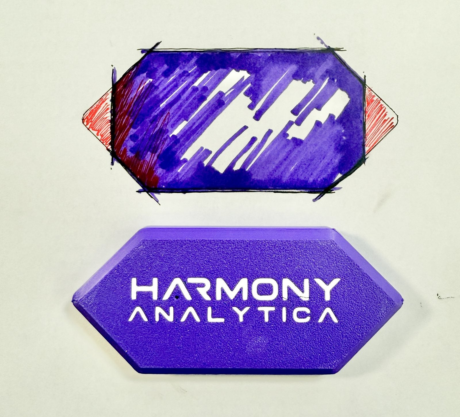 Marker sketch of the hexagonal housing above the finished 3D-printed purple top with the Harmony Analytica name cut through it