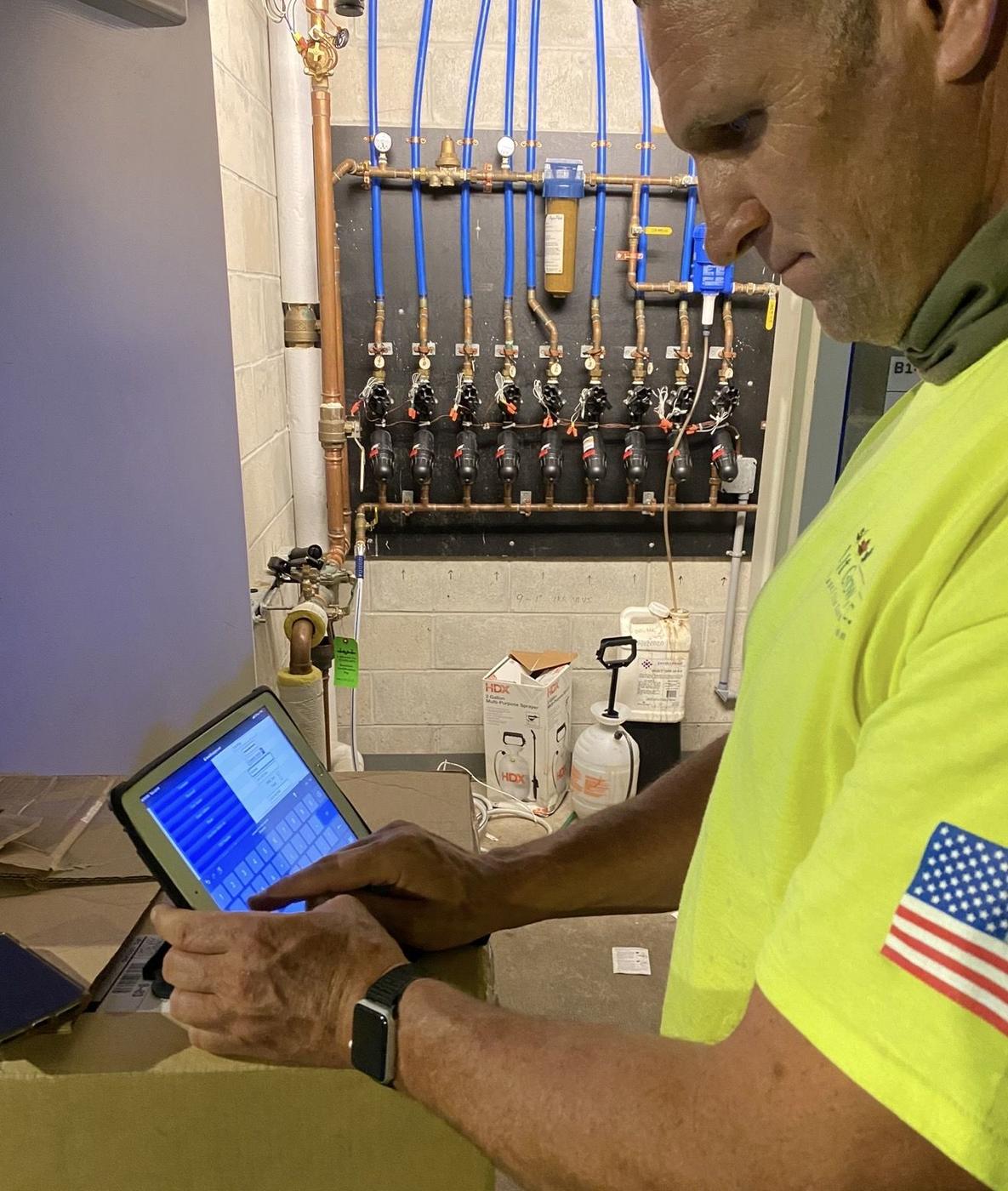 Technician reviewing live data on a tablet in a mechanical room
