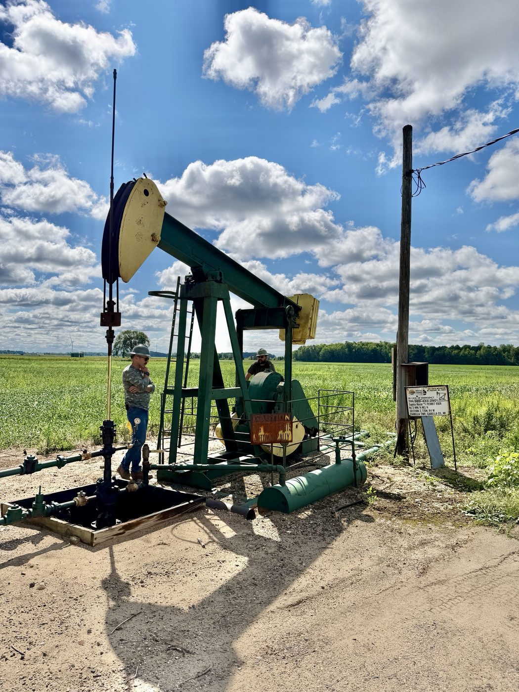 Harmony Analytica consultants at a pumpjack wellhead in central Michigan