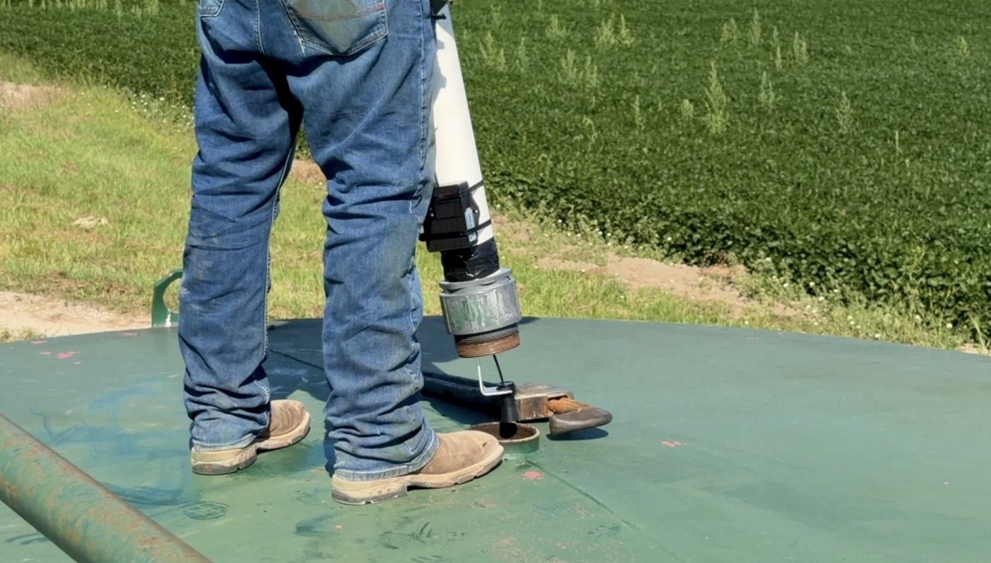 Close-up of a LoRaWAN level sensor mounted on a storage tank hatch