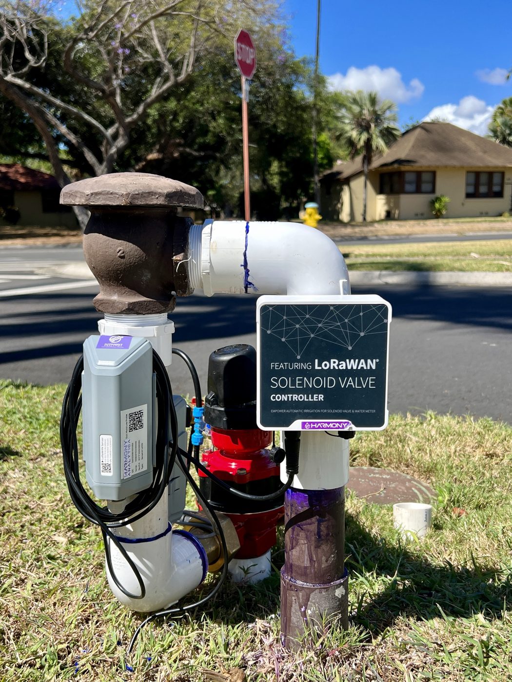 LoRaWAN solenoid valve controller, flow meter and soil moisture sensor on an irrigation riser in a roadway median